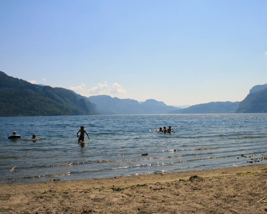People swimming in the fjord at Nesøyra beach