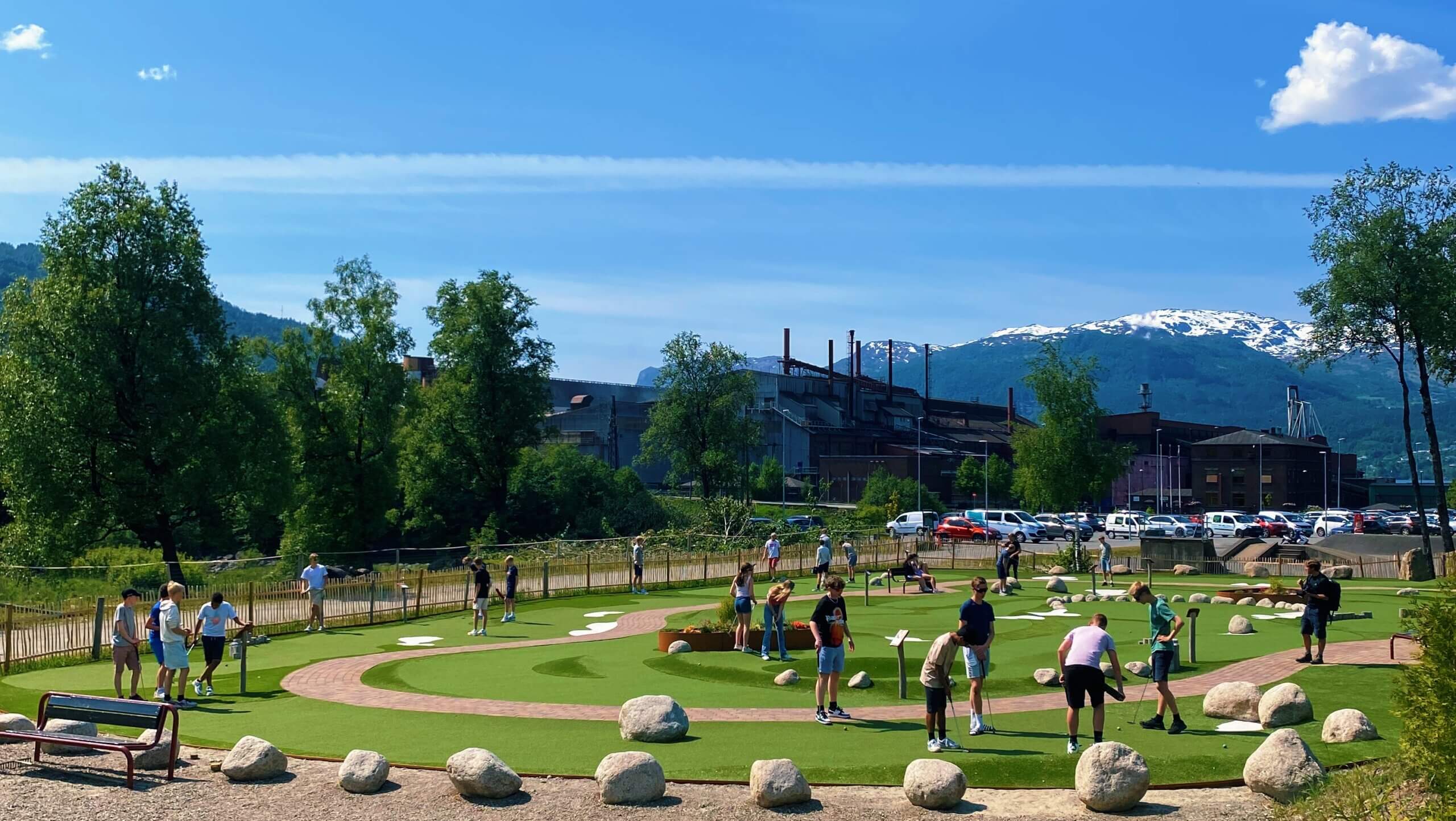 People playing minigolf on a summer's day in Sauda, Norway.