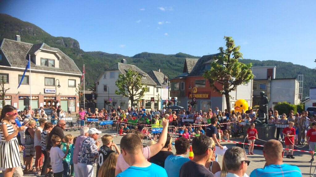 People at an outdoors festival in Sauda in May. Blue skies.